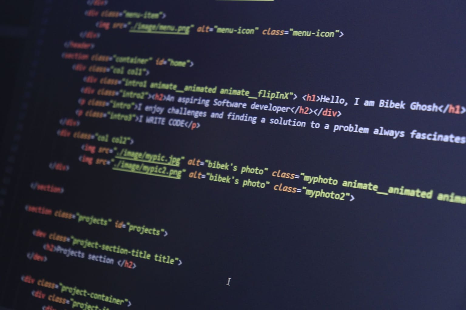 A computer screen displays HTML code, including image tags, text about an aspiring software developer, and project sections
