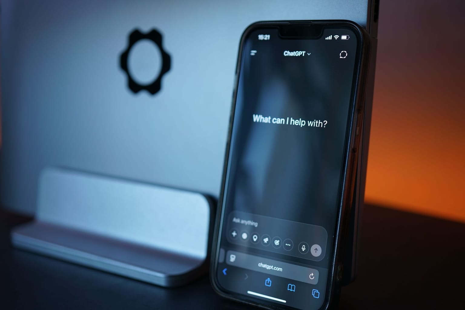 A smartphone displays an AI chat app with a conversation prompt on screen