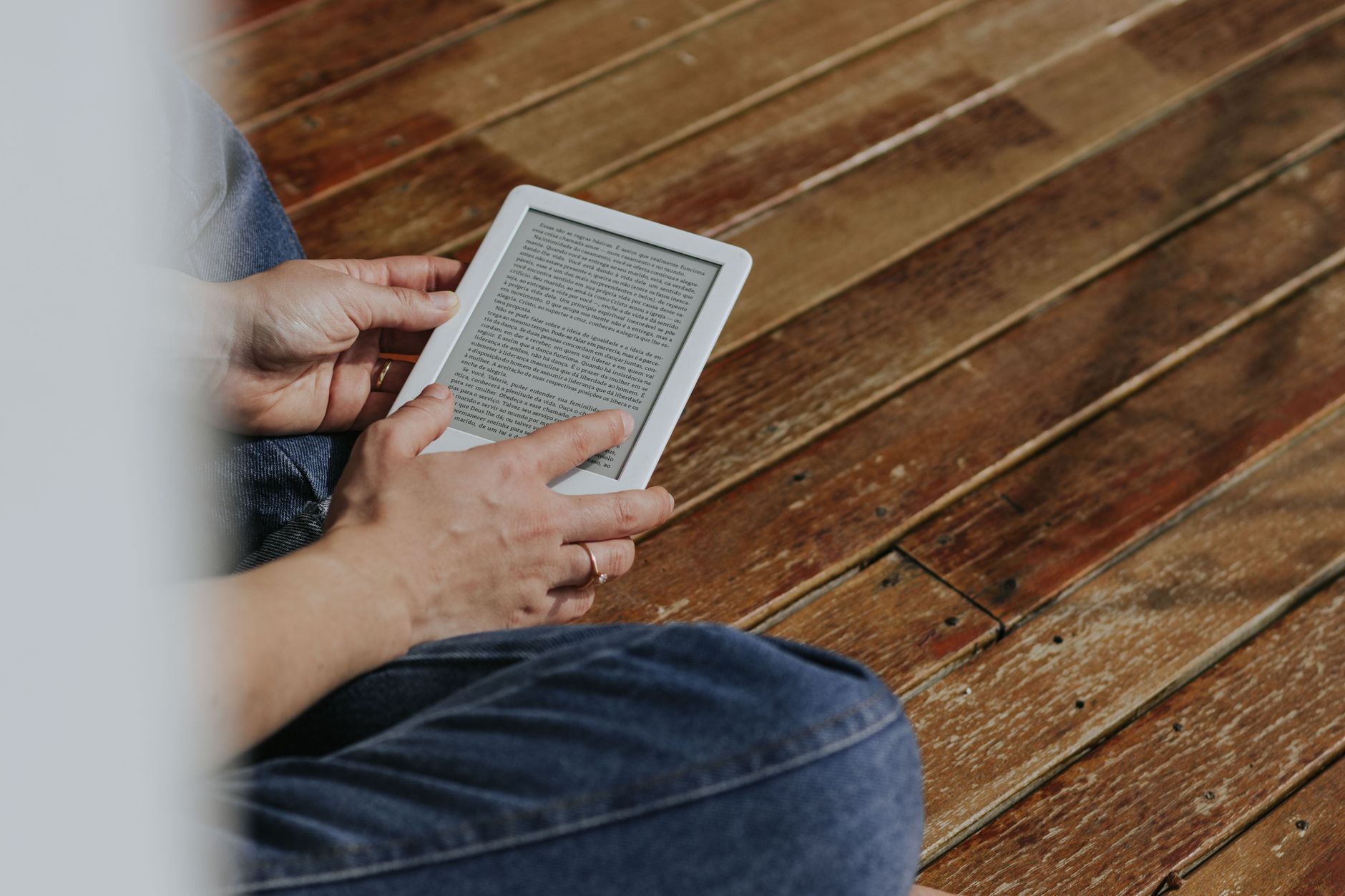 Hands holding an e-reader, the ebook format Designrr turns blog posts and documents into