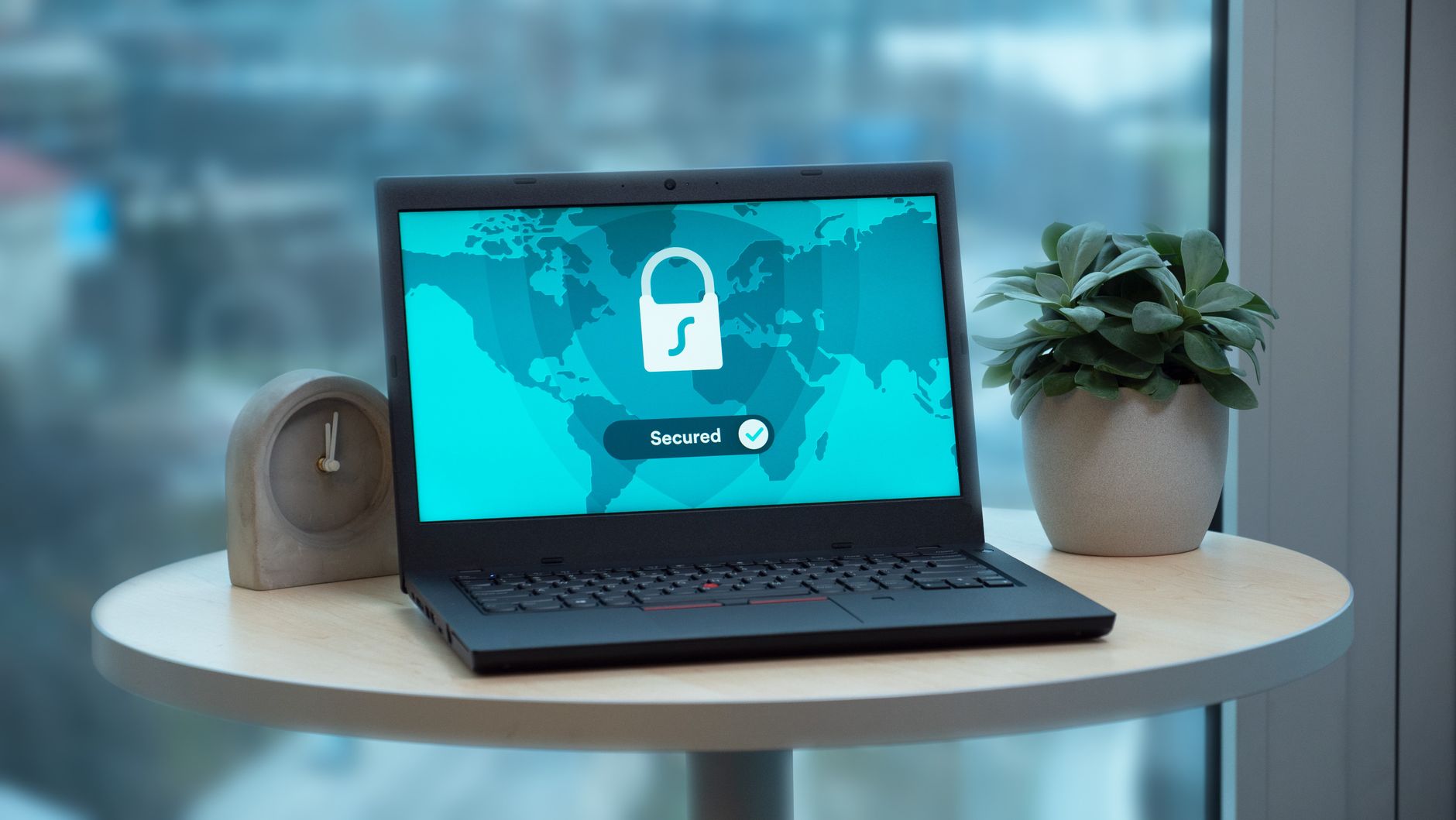 A laptop showing a security padlock icon on a table, the zero-knowledge encryption Icedrive sells its lifetime plan on