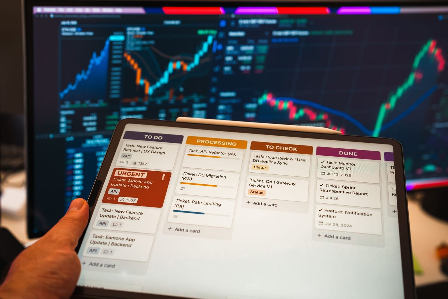 A person holds a tablet displaying a digital task board with columns for to-do, processing, to check