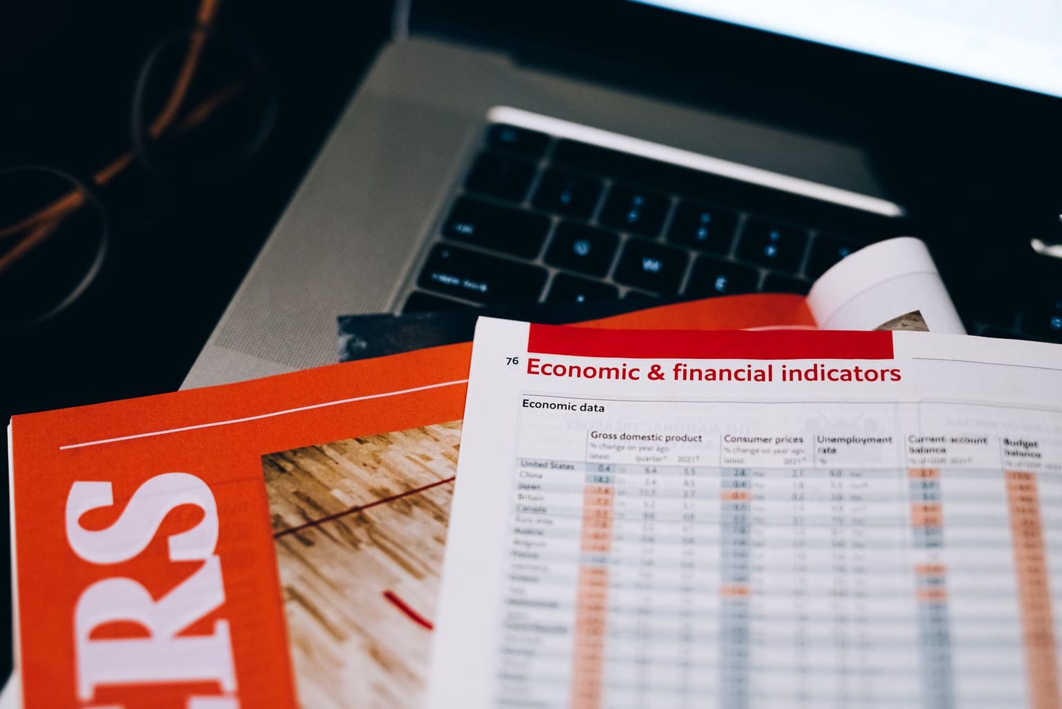 A close-up of a printed report titled “Economic & financial indicators” featuring charts and tables reminiscent of a data table